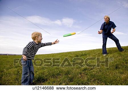 Boy and father play frisbee View Large Photo Image Stock Photo - Boy and father play frisbee. Fotosearch