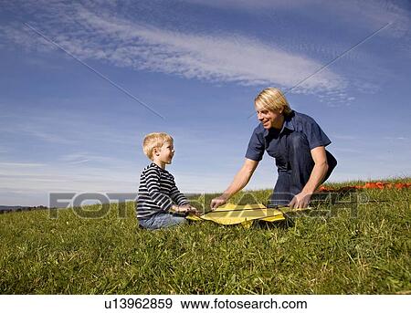 Stock Photo - Boy and father put together a Kite. Fotosearch