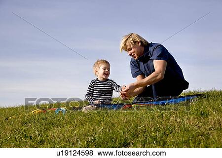 Boy and father put together a Kite View Large Photo Image Stock Photo - Boy and father put together a Kite. Fotosearch