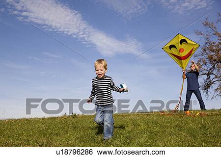 Boy and father start a Kite View Large Photo Image Stock Photograph - Boy and father start a Kite. Fotosearch