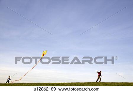 Stock Photo - Boy and Girl fly a Kite. Fotosearch