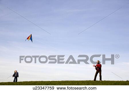 Boy and Girl fly a Kite View Large Photo Image Stock Photo - Boy and Girl fly a Kite. Fotosearch