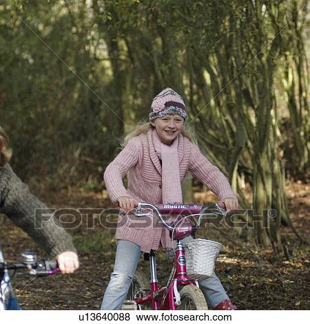 Stock Photo - Boy and girl riding bikes in countryside. Fotosearch