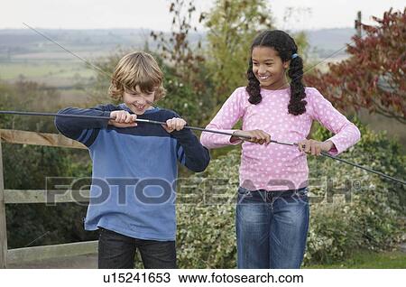 Boy and girl with tent poles View Large Photo Image Stock Image - Boy and girl with tent poles. Fotosearch