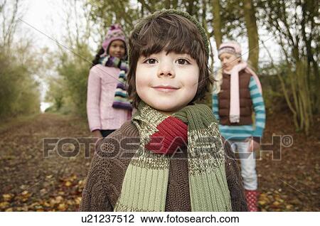 Stock Image - Boy and two girls on country lane. Fotosearch