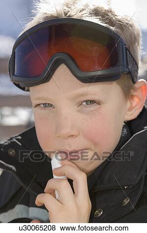 Boy applying lipsalve View Large Photo Image Stock Photo - Boy applying lipsalve. Fotosearch