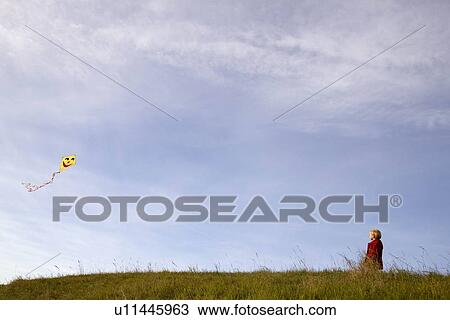 Boy flying a Kite View Large Photo Image Stock Image - Boy flying a Kite. Fotosearch