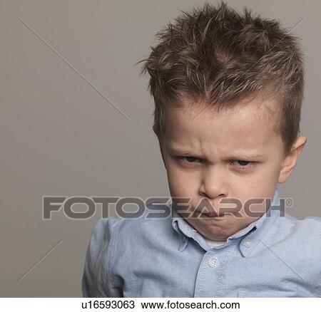 Stock Image - "Boy frowning, portrait, close-up". Fotosearch