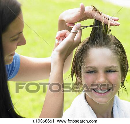 Boy gets his hair cut by woman View Large Photo Image Stock Image - Boy gets his hair cut by woman. Fotosearch