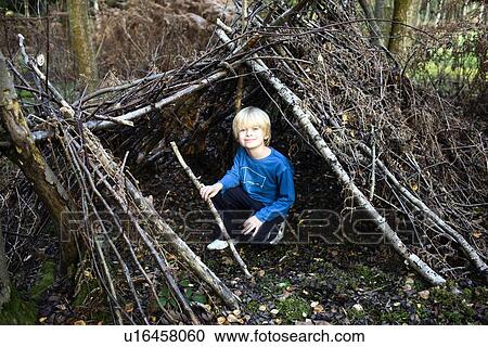 Boy in hut made of Tree branches View Large Photo Image Stock Image - Boy in hut made of Tree branches. Fotosearch