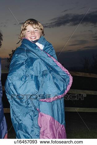 Boy in sleeping bag at dusk View Large Photo Image Stock Image - Boy in sleeping bag at dusk. Fotosearch