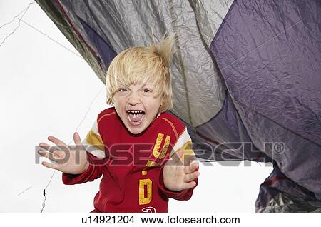 Picture - Boy playing under tent. Fotosearch
