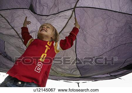 Stock Photo - Boy playing under tent. Fotosearch