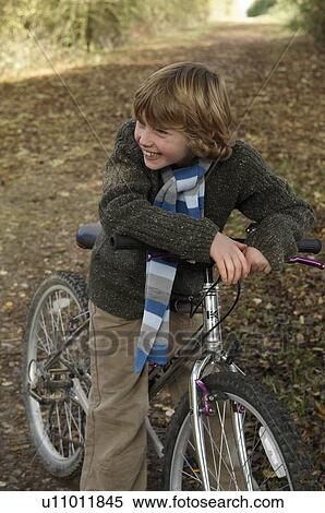 Stock Photography - Boy with bike on country lane. Fotosearch