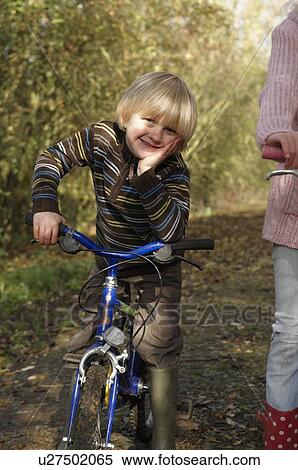 Stock Photography - Boy with bike on country lane. Fotosearch