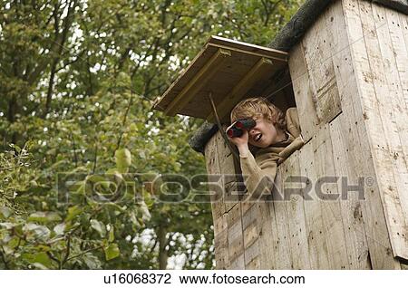 Boy with binoculars in treehouse View Large Photo Image Stock Image - Boy with binoculars in treehouse. Fotosearch