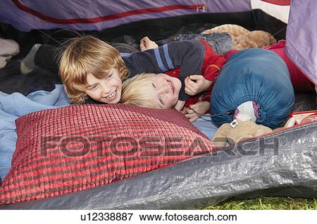 Stock Photo - Boys playing of tent. Fotosearch
