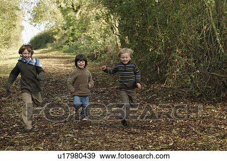 Stock Photo - Boys running down country lane. Fotosearch