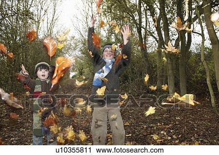 Boys throwing autumn leaves View Large Photo Image Stock Image - Boys throwing autumn leaves. Fotosearch
