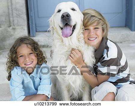 Stock Photo - Brother and sister with their dog. Fotosearch