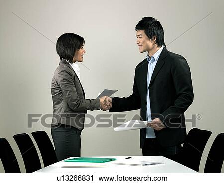 Stock Image - Business colleagues shaking hands. Fotosearch