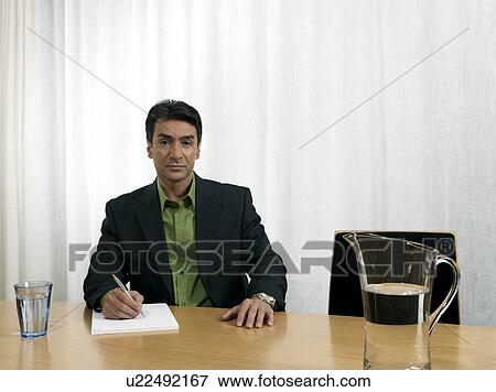 Stock Photo - Business man by conference table. Fotosearch