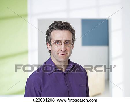 Stock Photo - Business man standing in loft. Fotosearch