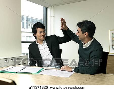 Stock Photography - Business men celebrating. Fotosearch