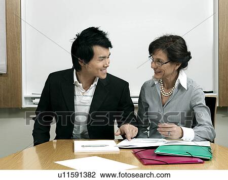 Stock Image - Business woman and trainee. Fotosearch