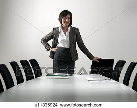 Business woman by conference table View Large Photo Image Picture - Business woman by conference table. Fotosearch