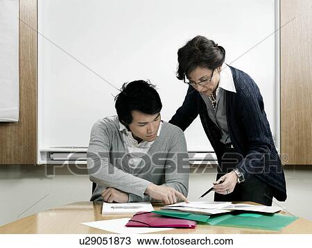 Business woman helping trainee View Large Photo Image Stock Image - Business woman helping trainee. Fotosearch