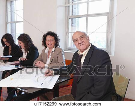 Stock Photo - Businesspeople in conference room. Fotosearch
