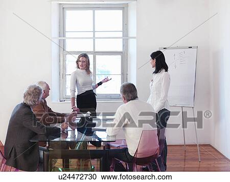 Businesswomen giving presentation View Large Photo Image Stock Image - Businesswomen giving presentation. Fotosearch