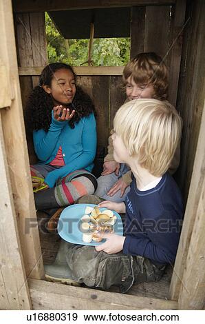 Stock Photo - Children having picnic in treehouse. Fotosearch