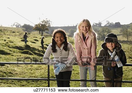 Children on gate in countryside View Large Photo Image Stock Image - Children on gate in countryside. Fotosearch