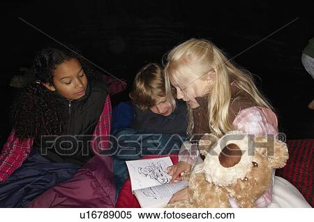 Stock Photography - Children reading in tent. Fotosearch
