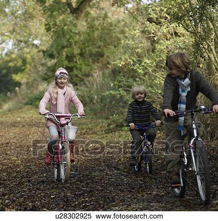 Stock Photography - Children riding bikes in countryside. Fotosearch