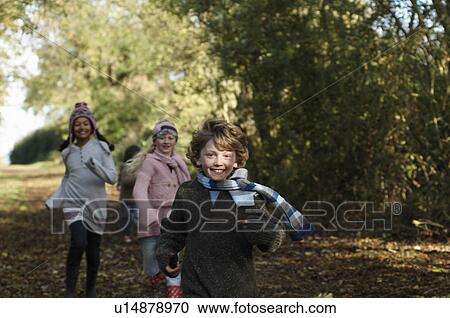Stock Image - Children running down country lane. Fotosearch