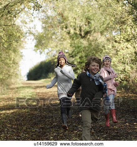 Stock Photo - Children running down country lane. Fotosearch