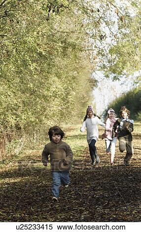 Stock Photography - Children running down country lane. Fotosearch