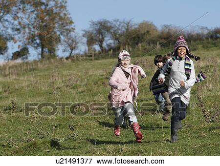 Stock Photo - Children running in countryside. Fotosearch