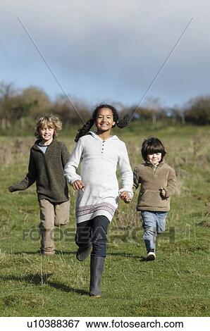 Children running in field View Large Photo Image Stock Photo - Children running in field. Fotosearch
