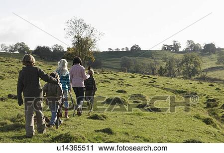 Stock Image - Children walking in field. Fotosearch