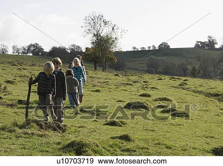 Stock Photo - Children walking in field. Fotosearch