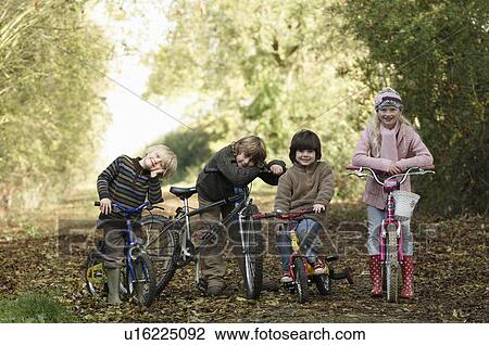 Children with bikes on country lane View Large Photo Image Stock Image - Children with bikes on country lane. Fotosearch