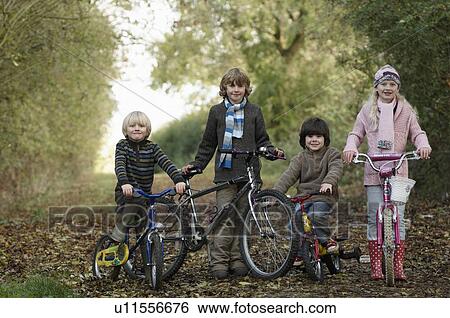 Stock Photograph - Children with bikes on country lane. Fotosearch