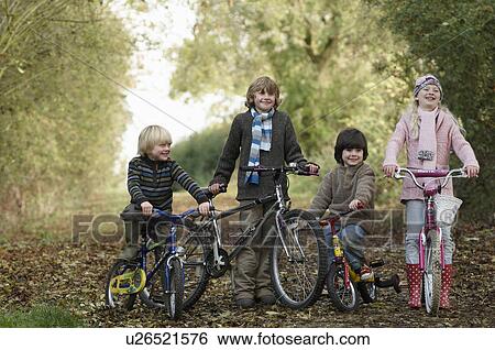 Children with bikes on country lane View Large Photo Image Stock Photograph - Children with bikes on country lane. Fotosearch