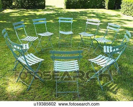 Stock Image - "Circle of chairs, outdoors". Fotosearch