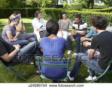 Picture - "Circle of people in rehab, outdoors". Fotosearch