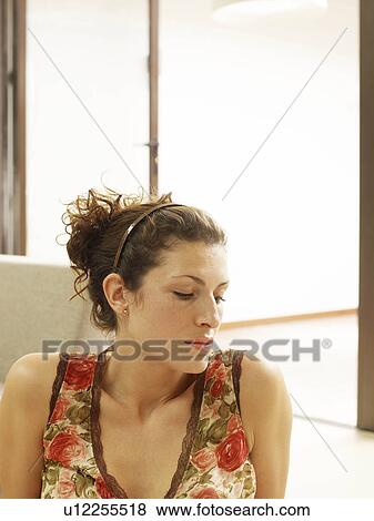 Stock Photo - Close up of woman looking downwards. Fotosearch